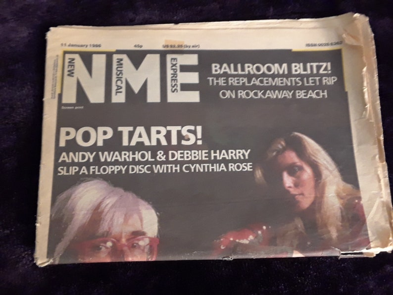 May include: A vintage issue of New Musical Express (NME) magazine from January 11, 1996. The cover features the headline "Pop Tarts!" with Andy Warhol and Debbie Harry. Additional text includes "Ballroom Blitz!" and "The Replacements Let Rip on Rockaway Beach."