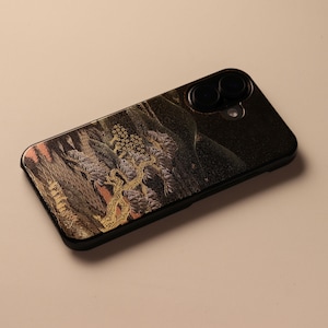 May include: Black smartphone case with an intricate, colorful design featuring a landscape with trees and foliage. The case has a glossy finish and a camera cutout. The design incorporates gold, pink, and purple hues.