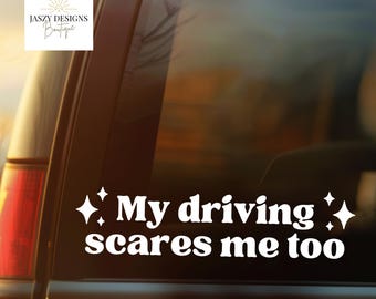 May include: A white vinyl decal applied to a car window featuring the text My driving scares me too in a bold, rounded font. The text is flanked by four-pointed star icons on both sides, creating a decorative graphic for vehicle glass surfaces.