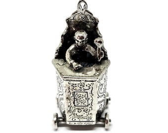 Silver miniature child in a high chair. Dutch silver hallmarked.