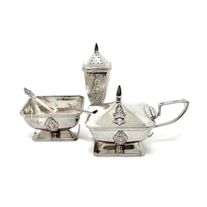 Sterling salt cellar, pepper shaker and Mustard pot Siam (Thailand) silver five (5) piece condiment set with decorated Deity Figures.