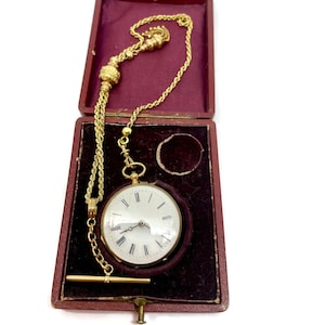 Courvoisier Frères etui with 32 mm key wind ladies pocket watch, pocket watch. Gold with a gold marked watch chain and original box