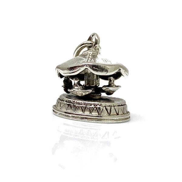Spinning Carousel Charm . Vintage Sterling Silver  The carousel spins around just like a real carousel does.Hallmarked Nuvo Reg. Silver