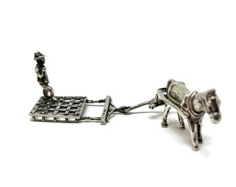 Miniature silver farmer with plow and horse figurine. Silver hallmarked Amsterdam