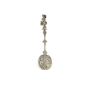 Dutch Silver spoon. On top Figure with Lantern and umbrella, bowl decorated with repousse pub scene Silver hallarked