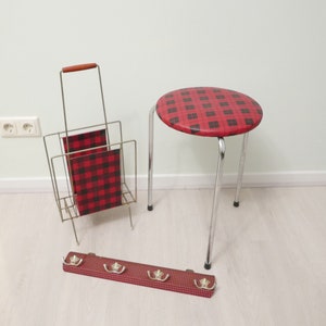 May include: A set of three vintage home decor items in a red and black plaid pattern. The set includes a magazine rack, a stool, and a coat rack with hooks.