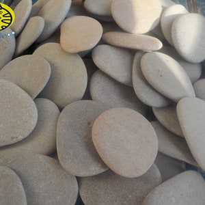 May include: A pile of smooth, gray stones, perfect for crafts, home decor, or garden accents.
