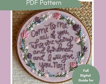 May include: A pink embroidery hoop with the text "Come to Me" and a floral design. The text is in a cursive font. The hoop is surrounded by a wooden frame. The image also includes the text "Full Digital Guide for hoops 12.7cm-20.3cm".