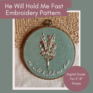 May include: An embroidery hoop with a teal fabric background features a floral design in white, cream, and red thread. The text "He will hold me fast" is embroidered around the edge. The image also includes text that says "Digital Guide For 12.7cm-20.3cm Hoops."