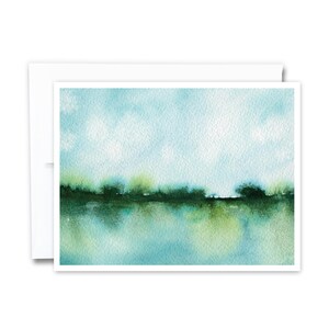 May include: A watercolor painting of a landscape with a blue sky, green trees, and a reflection of the trees in the water.