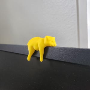 May include: A white ceramic mug with a black handle and the text "But first, coffee" in a black, handwritten-style font. The mug is on a white surface.