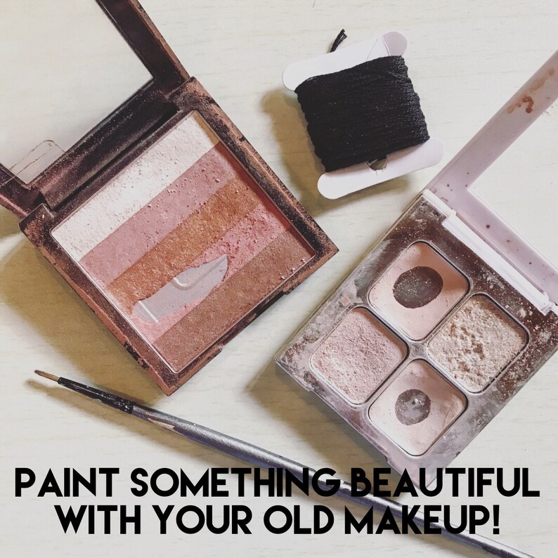 May include: Two palettes of makeup with a variety of colors and textures. The palettes are open and show the different shades of eyeshadow. The text "PAINT SOMETHING BEAUTIFUL WITH YOUR OLD MAKEUP!" is written below the palettes.