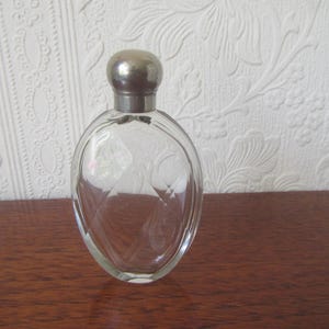 Vintage faceted glass bottle. Scent, perfume cologne bottle. Silver-tone metal screw top. Collectible glass.