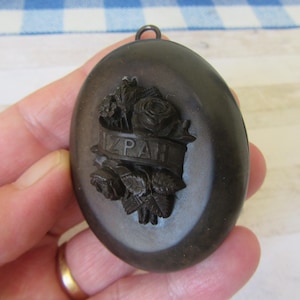 Antique 19th century Vulcanite Mizpah picture frame locket. Raised floral detailed double photo frame with glass covers. Mourning locket.
