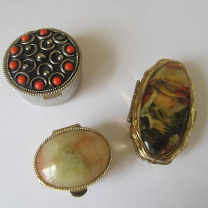 Pill boxes Choice of 3. 1 ashtray red stones and 2 pill boxes cream/peach stone. Paris Fantaisie girl with bonnet.