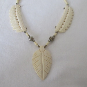 Vintage bovine bone handcarved necklace.Silvertone metal hook fastener and beads,leaf shape pendant.