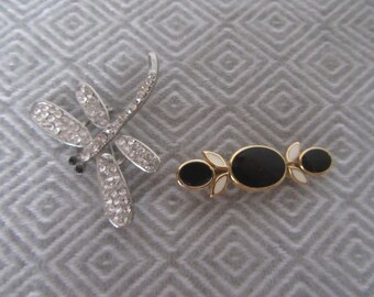 Set of 2 brooches. Rhinestones Dragonfly in silvertone metal and black and white enamel effect on goldtone metal.