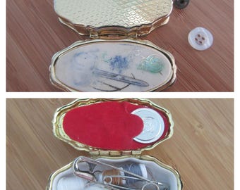 Vintage Etui travel needlecase. Gold-tone metal oval case with sewing design top. Pill box style needles cottons case.