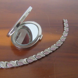 Oval chrome plated double mirror compact and pink stones,silvertone metal bracelet..