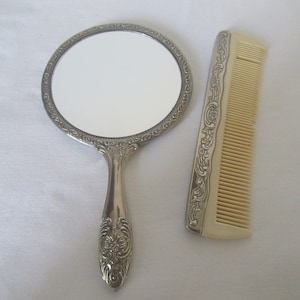 Vintage silver plated vanity set handheld mirror and comb.Film,photo,theatre prop.Dressing table display.Bedroom decor.