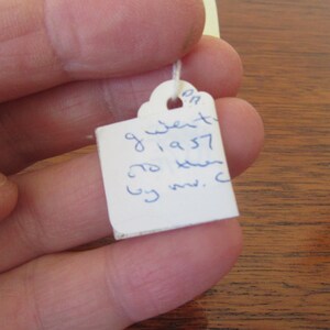 May include: White tag with blue ink handwritten text: "9 went to 1957 to keen by mv. c"