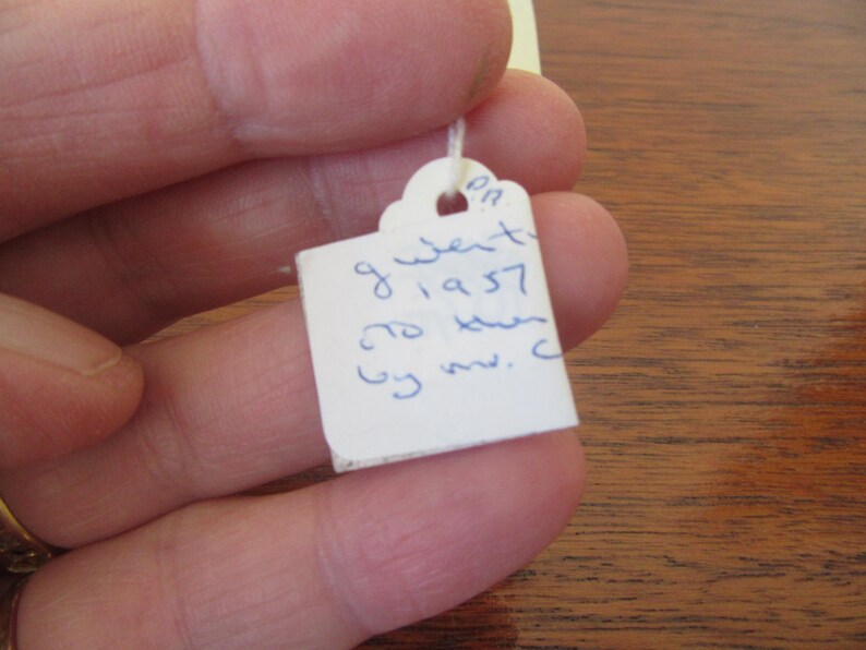 May include: White tag with blue ink handwritten text: "9 went to 1957 to keen by mv. c"