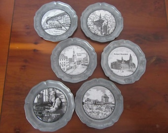 Set of 6 German pewter coasters,porcelain decorated centres depicting landmarks,famous people,places of interest etc  With Angel Hallmark.