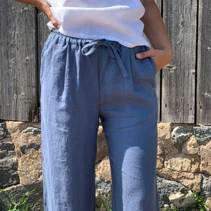 Pants with side pockets and a tie waist for an adjustable fit. The lightweight fabric is perfect for summer, providing comfort and breathability.