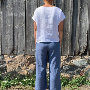 Back view of loose-fitting linen pants for women, featuring a relaxed wide-leg style.