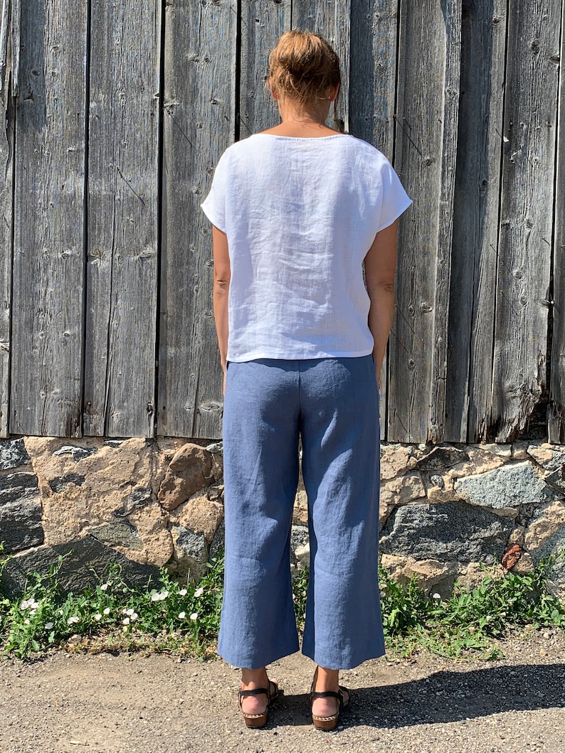 Back view of loose-fitting linen pants for women, featuring a relaxed wide-leg style.