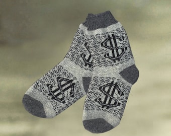 May include: A pair of gray and black socks with a dollar sign pattern. The socks are made of a soft, knitted fabric.