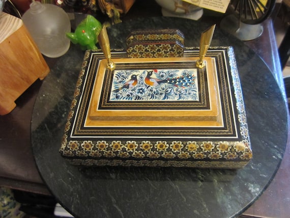 Centuries-old Persian Khatam marquetry — thousands of hand-laid micro-inlaid pieces of wood, bone, and metal — turned into a functional desk organizer that doubles as heirloom art.
