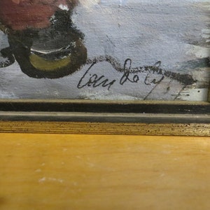 May include: A framed painting with a black frame and a gold trim. The painting is of a winter scene with a signature in the bottom right corner that reads "Lilly de Lyf."