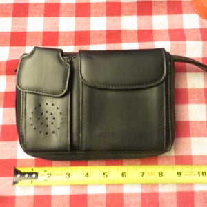 May include: Black leather zippered pouch with multiple compartments and a strap. The pouch is 8 inches long.