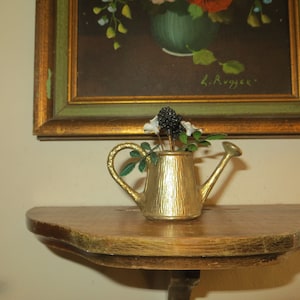 Old Miniature Watering Can with flowers.