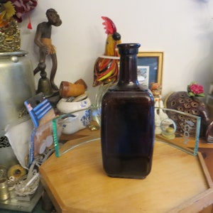 Antique brown bottle with broken cork top
