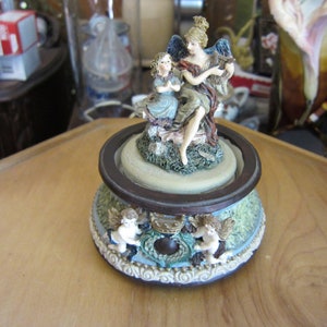 Angel and child musical figurines. key wind.