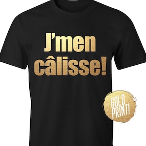 May include: Black t-shirt with gold text that reads "J'men caisse!"  The text is in a bold, blocky font.  The shirt has a gold "Gold Print!" label on the bottom right corner.
