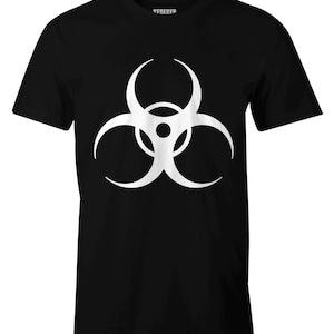May include: A black short-sleeved t-shirt featuring a large, white biohazard symbol printed on the center of the chest. The garment has a crew neckline and a straight hemline. The interior neck label displays the text VEREVER in white lettering.