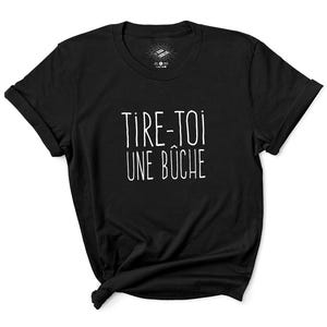 May include: Black t-shirt with white text that reads "TIRE-TOI UNE BUCHE"