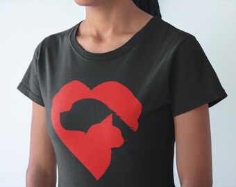 May include: A black short-sleeved t-shirt featuring a large red graphic print on the chest. The graphic is a heart shape formed by the silhouettes of a dog and a cat facing each other, with the dog on the left and the cat on the right.