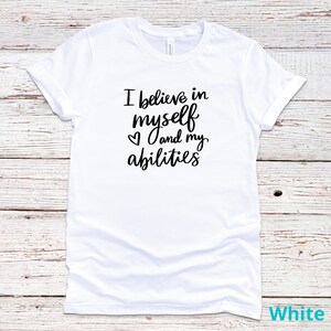 May include: White t-shirt with black text that reads "I believe in myself ♥ and my abilities".