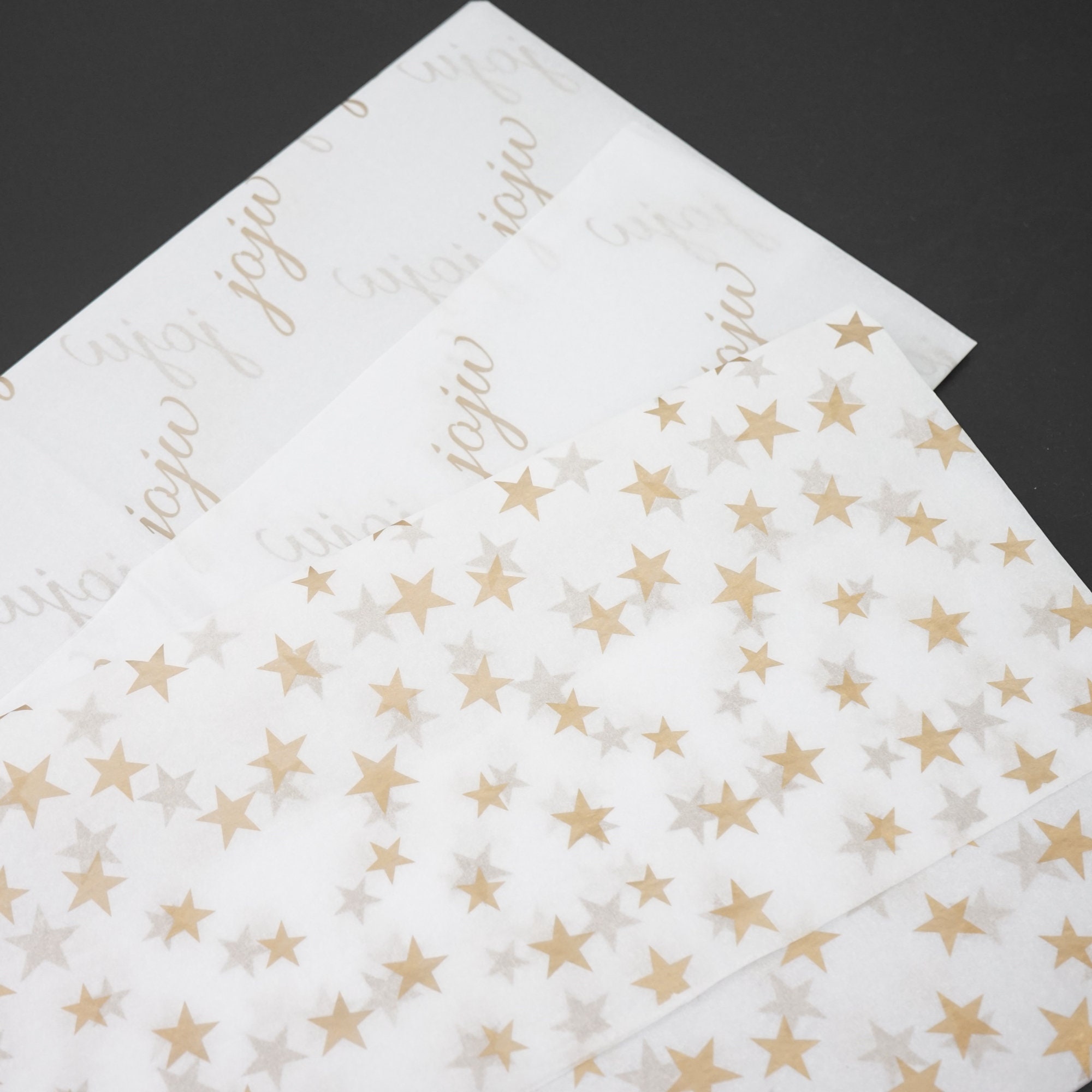 Gold+Star+Patterned+Tissue+Paper+from+Midpac+Packaging.+White+Tissue+Paper+with+a+gold+star+print+across+the+sheet.