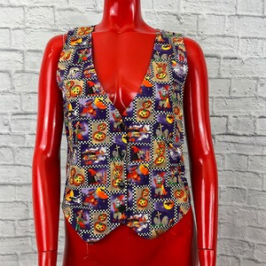 May include: A purple vest with a Halloween-themed print featuring pumpkins, witches, bats, and other spooky imagery.