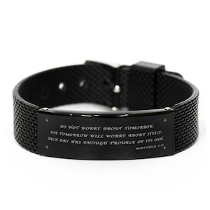 May include: Black silicone bracelet with a black metal plate engraved with the quote "Do not worry about tomorrow, for tomorrow will worry about itself. Each day has enough trouble of its own. Matthew 6:34".