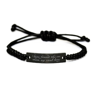 May include: Black braided bracelet with a black metal tag that reads "I have found the one whom my soul loves Song 3:4".