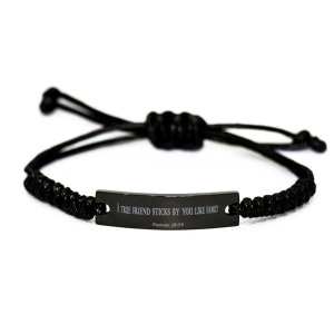 Puede incluir: Pulsera trenzada negra con una etiqueta de metal negro que dice "Un verdadero amigo se mantiene a tu lado como la familia, Proverbios 18:24".