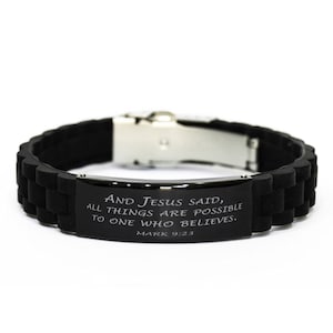 May include: Black silicone bracelet with a silver clasp and a black metal plate with the inscription "AND JESUS SAID, ALL THINGS ARE POSSIBLE TO ONE WHO BELIEVES. MARK 9:23"