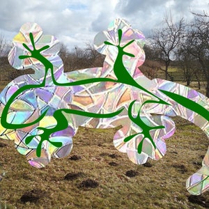 May include: An abstract lizard design featuring green outlines and a stained-glass effect. The lizard is set against a natural outdoor backdrop with trees and a cloudy sky. The design is artistic and visually striking.