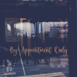 May include: A shop window with the text "By Appointment Only" in a cursive script. The window reflects the street scene, including a car and buildings. The image has a dark blue and brown color palette.